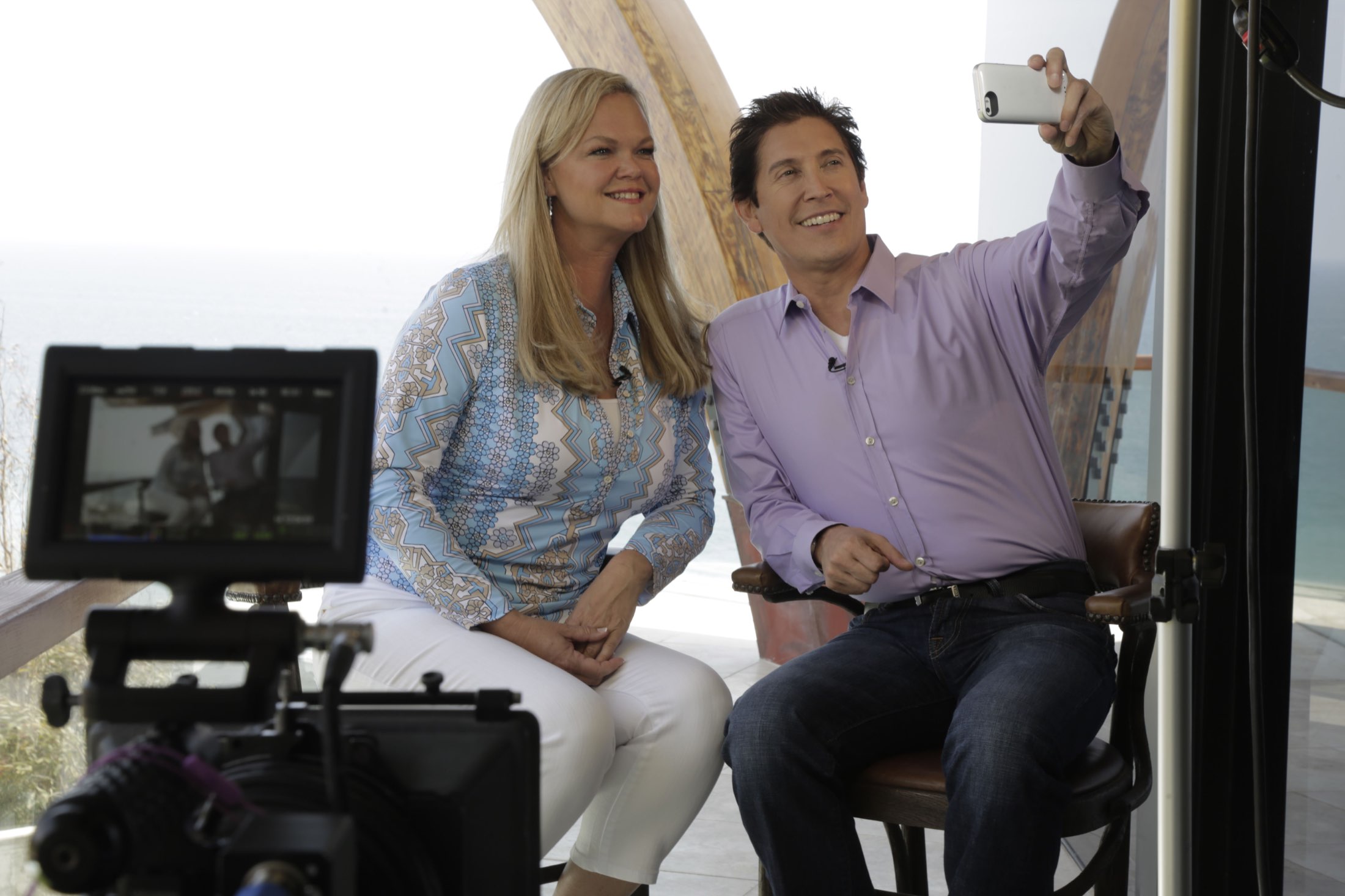 A broadcast interview being filmed on set, faces to camera